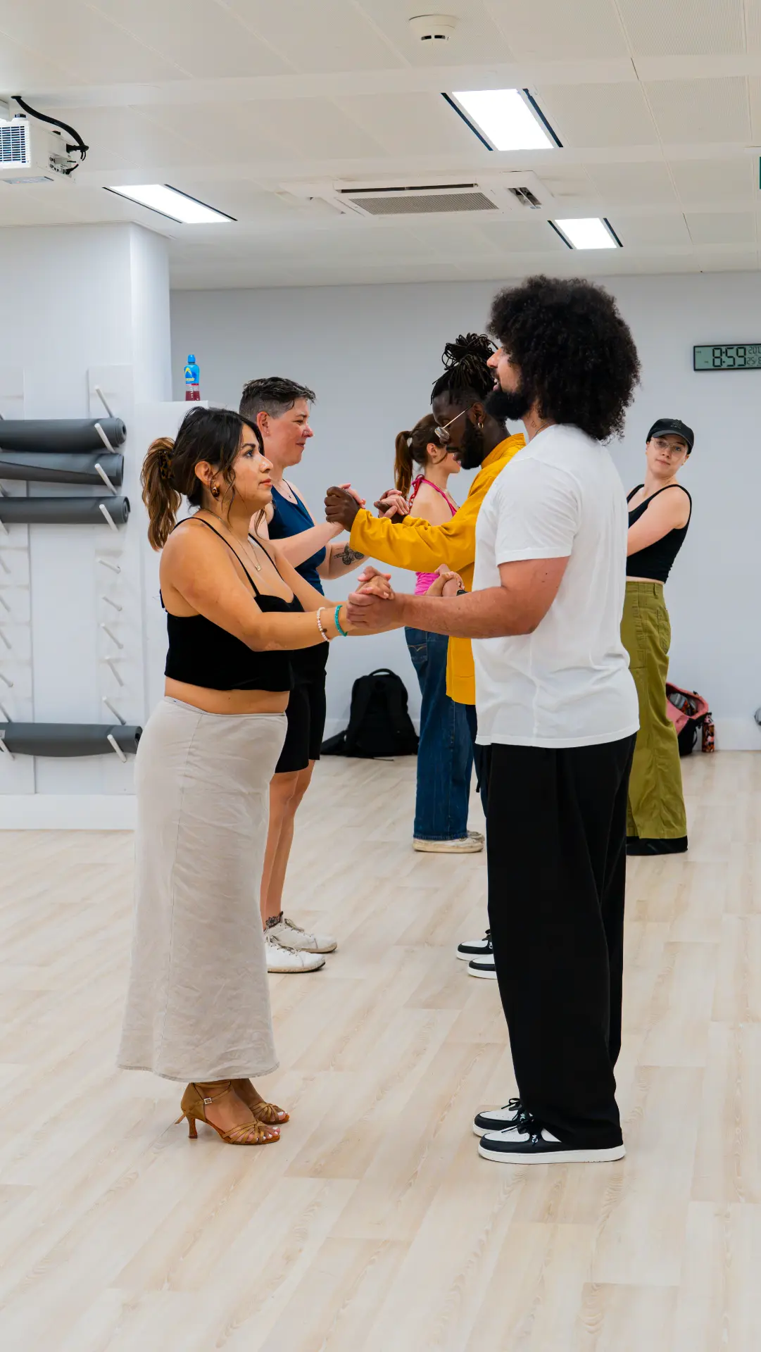 A line of students working on partnerwork in the studio